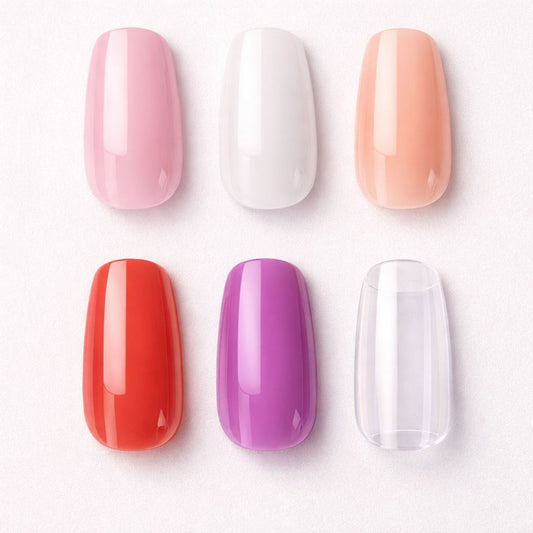 Set of six colorful nail polish samples on a white background